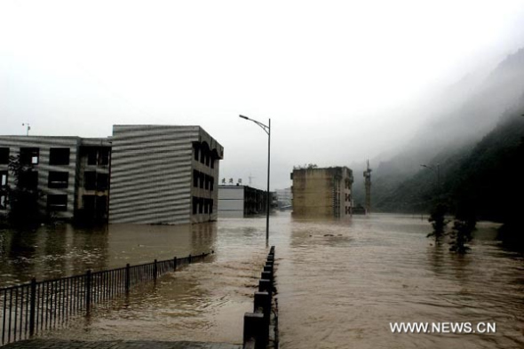 Buildings are flooded in rainstorm-hit Beichuan Qiang Autonomous County, southwest China's Sichuan Province, July 9, 2013. Downpours have submerged the quake-razed old town ruins of Beichuan, which was hit by an 8.0-magnitude earthquake in May 2008. (Xinhua/Wang Guanlun)