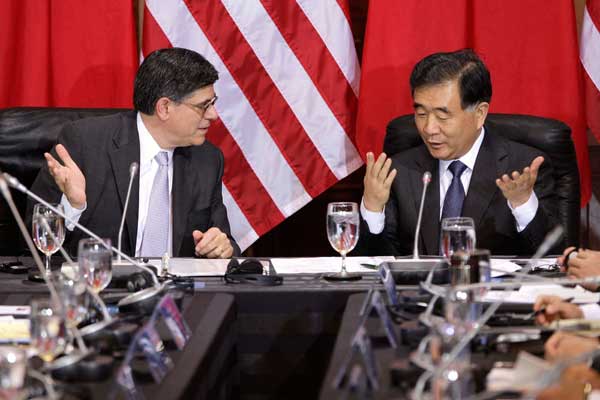 China's Vice-Premier Wang Yang (right) and US Treasury Secretary Jacob Lew smile and shake hands at the start of the China-US Strategic and Economic Dialogue at the Treasury Department in Washington on Wednesday. Jonathan Ernst / reuters