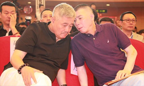 Feng Xiaogang (right) speaks with Zhao Benshan at Friday's press conference. Photo: Courtesy of CCTV