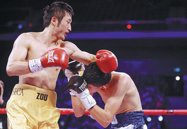 China's Zou Shiming throws a left hook en route to a unanimous decision over Mexico's Eleazar Valenzuela in their four-round flyweight bout on April 6 in Macao. Dale de la Rey / Agence France-Presse