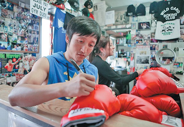 Zou Shiming signs autographs before a training session in Hollywood, California, for his upcoming bout with Jesus Ortega. Lucy Nicholson / Reuters