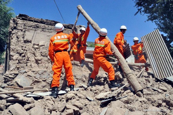 Rescuers clear the debris of a damaged house in quake-hit Majiagou Village of Minxian County, northwest China's Gansu Province, July 22, 2013. Fifty-four deaths have so far been confirmed in the 6.6-magnitude earthquake which jolted a juncture region of Minxian County and Zhangxian County in Dingxi City Monday morning. (Xinhua/Guo Gang)