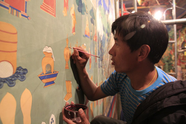 Puntsog, from Lhundrub county, and his teacher spent 18 months restoring a 12-square-meter fresco in Lhasa's Ramoche Temple. Wang Huazhong / China Daily