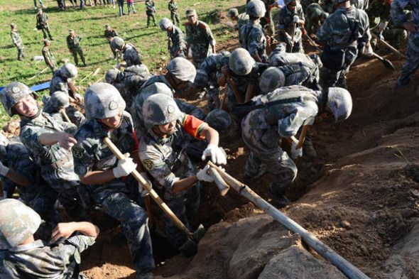 Rescuers work at Yongguang Village of Meichuan Town in Minxian County, northwest China's Gansu Province, July 22, 2013. The death toll has climbed to 89 in the 6.6-magnitude earthquake which jolted a juncture region of Minxian County and Zhangxian County in Dingxi City Monday morning. (Xinhua/Zhang Yongjin)