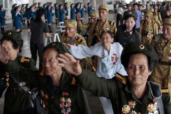 Veterans of the Korean War (1950-53) from across the Democratic Peoples Republic of Korea arrive in Pyongyang on Tuesday as the country prepares to mark the 60th anniversary of the end of the war, on Saturday. PHOTO BY JON CHOI-JIN / ASSOCIATED PRESS