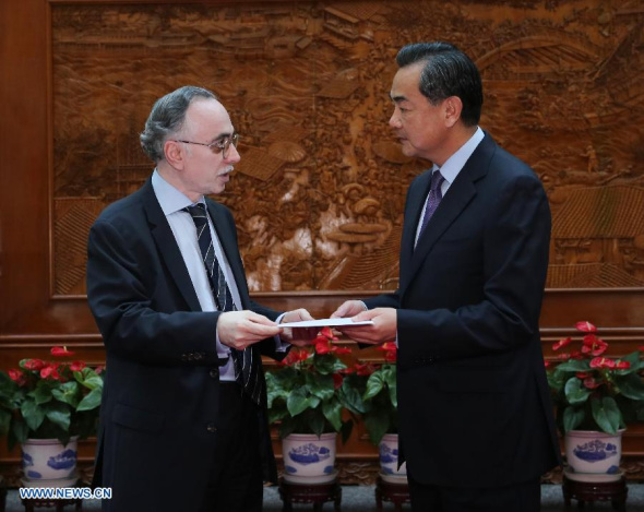 Chinese Foreign Minister Wang Yi (R) meets with Pakistan's Ambassador to China Masood Khalid in Beijing, capital of China, July 24, 2013, receiving a humanitarian donation of one million U.S. dollars from the Pakistani government to quake-hit areas in China. A 6.6-magnitude quake hit northwest China's Gansu Province on Monday morning, leaving 95 dead. (Xinhua/Liu Weibing)