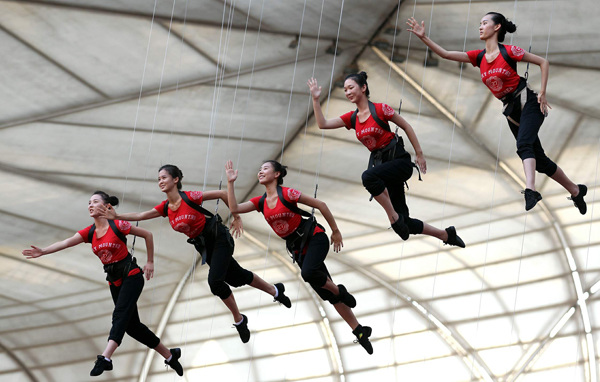 Acrobats rehearse the wire performance at the Bird's Nest for the show <i>Attraction</i>, which will be staged at the stadium from Sept 12 to Oct 7. [Photo by Zou Hong / China Daily]