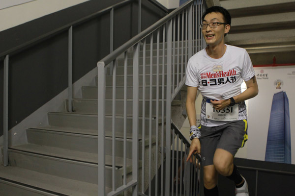 A runner climbs up stairs during the vertical marathon at the China World Summit Wing Hotel of the World Trade Center Tower 3 in Beijing on August 3, 2012. [Photo by Cui Meng/chinadaily.com.cn]