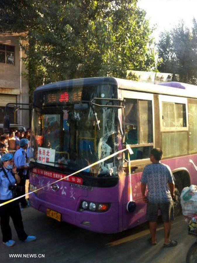 Photo taken with a mobile phone shows a bus which is cordoned off after a robbery incident happened in Anyang City, central China's Henan Province, Aug. 19, 2013. Two people have been killed and another 13 injured after a knife-wielding man attempted to rob the bus Monday afternoon. (Xinhua) 