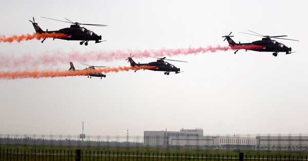 WZ-10 attack helicopters from the Fenglei aerobatic team perform at the Second China Helicopter Expo in Tianjin on Thursday. Fenglei is China's first helicopter aerobatic team, and one of only seven such teams in the world. CHENG GONG / FOR CHINA DAILY