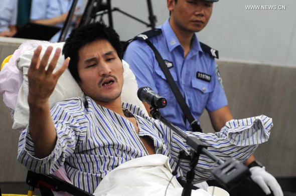 Ji Zhongxing, who is charged with causing a blast in the Beijing Capital International Airport in July, stands trial at the Beijing Chaoyang District People's Court, in Beijing, China, Sept. 17, 2013. Ji, a wheelchair-bound man from east China's Shandong Province, set off a homemade explosive device outside the airport's Terminal 3 arrivals exit on July 20, severely injuring himself. A police officer at the scene suffered minor injuries in the explosion. The Beijing Chaoyang District People's Procuratorate filed charges against Ji of causing an explosion on August 29. (Xinhua/Gong Lei) 