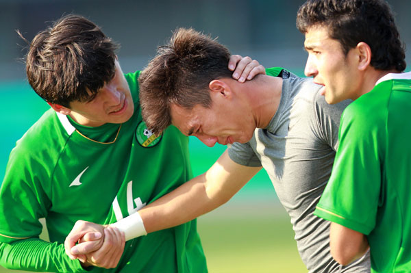 Erjet (center) the goalkeeper of the Xinjiang Uygur autonomous region's Under-20 soccer team, wept after losing the semifinal game. [Photo by Cui Meng / China Daily]