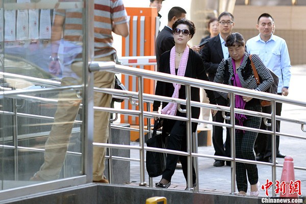 Chinese PLA singer Meng Ge (front), wife of PLA singer Li Shuangjiang, arrives at the People's Court of Haidian District for the first-instance verdict of the gang rape charge of her son Li Tianyi in Beijing on Thursday, Sept 26, 2013. (Photo: Chinanews.com/Jin Shuo)