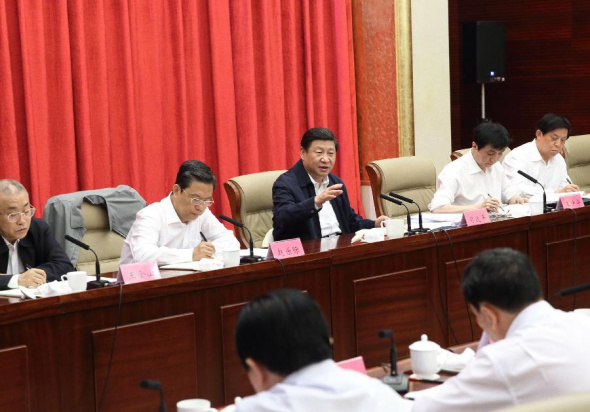 Xi Jinping (back, C), Chinese president and general secretary of the Communist Party of China Central Committee, participates in a session as part of the ongoing mass line campaign with standing committee members of the Party Committee of north China's Hebei Province, in Shijiazhuang, capital of Hebei, Sept. 23, 2013. The one-year mass-line campaign was launched in June by China's leaders to boost ties between CPC officials, members and the people, while cleaning up four undesirable work styles -- formalism, bureaucracy, hedonism and extravagance. (Xinhua/Lan Hongguang) 