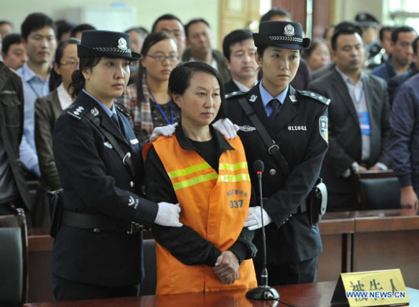 Gong Aiai, a former Chinese banker, is on trial at the People's Court of Jingbian County in northwest China's Shaanxi Province, Sept. 29, 2013. Gong, former deputy head of the Shenmu County Rural Commercial Bank in Yulin City, has been sentenced to three years in prison for forging and trading official documents, the court announced on Sunday. Gong, mocked by Chinese netizens as Sister House, was found with a huge number of properties purchased under fake IDs. (Xinhua/Ding Haitao) 