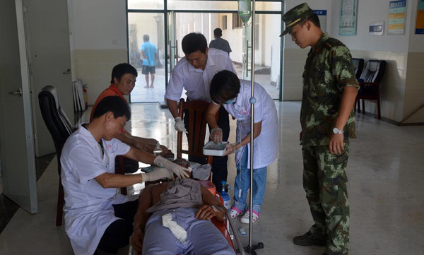 An injured fisherman receives treatment at Sansha municipal people's hospital in Sansha City, south China's Hainan Province, Sept. 30, 2013. A total of 74 people were confirmed missing while another 14 were rescued after three fishing boats sank Sunday afternoon during a typhoon in the South China Sea, China's maritime authorities said on Monday. (Xinhua/Wei Taoze)