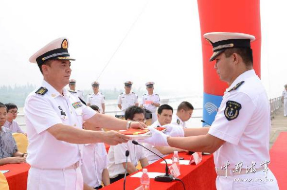 The photo features the scene of the naming and flag-presenting ceremony. The officers and men of a speedboat flotilla under the South China Sea Fleet of the Navy of the Chinese Peoples Liberation Army (PLAN) held a naming and flag-presenting ceremony for the new-type minesweeping ship Heshan on the morning of October 10, 2013 at a military port in Jiangmen city of south Chinas Guangdong province, marking that another new-type minesweeping ship is officially commissioned to the PLAN. (Chinamil.com.cn/ Liu Xin and Gao Yi)