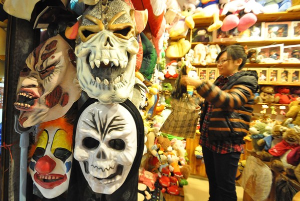 Masks, costumes and other Halloween-related merchandise are displayed at a store in Handan, Hebei province, on Wednesday, the day before the celebration. Halloween has become more popular in China, but some of its scarier masks and costumes cause concern that they may affect children negatively. He Qunying / For China Daily