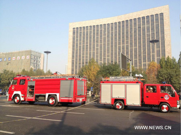 Fire engines are seen at the accident site after explosions on the Yingze Street in Taiyuan, capital of north China' Shanxi Province, Nov. 6, 2013.  (Xinhua/Fan Minda)