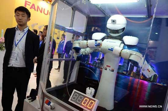 A robot plays with a magic cube during the 15th China International Industry Fair in Shanghai, east China, Nov. 5, 2013. A total of 1,979 exhibitors from 25 countries and regions took part in the five-day fair which kicked off here Tuesday. (Xinhua/Lai Xinlin)