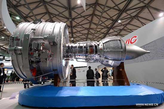 Visitors view the model of a domestic plane engine during the 15th China International Industry Fair in Shanghai, east China, Nov. 5, 2013. (Xinhua/Lai Xinlin)