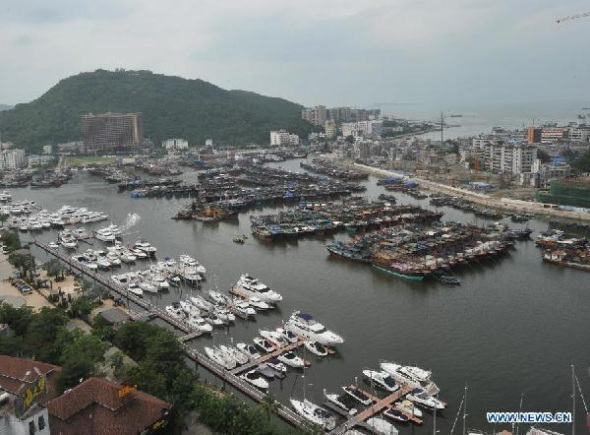 Fishing boats take shelter at the Sanya Harbor to avoid the typhoon Haiyan in Sanya City, south China's Hainan Province, Nov. 9, 2013. Haiyan, the 30th and strongest typhoon to hit China this year, is now influencing the South China Sea. (Xinhua/Zhang Yongfeng)