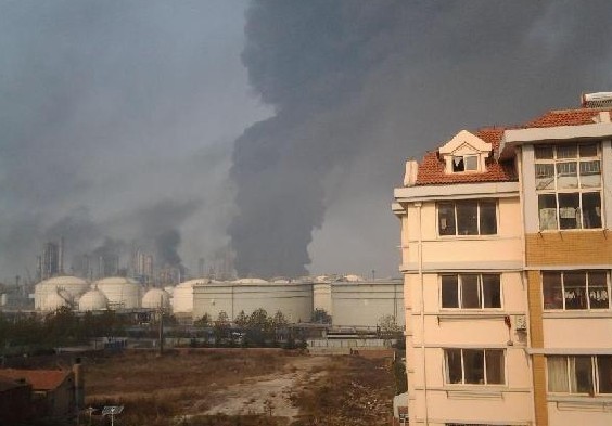 Photo taken with a mobile phone shows the site of a pipeline explosion in Qingdao, east China's Shandong Province, Nov. 22, 2013. A fire broke out and the blast occurred around 10 a.m. in the Huangdao District when workers were repairing a petroleum pipeline which broke and resulted in an oil leakage around 3 a.m. Casualties remained unknown. (Xinhua)