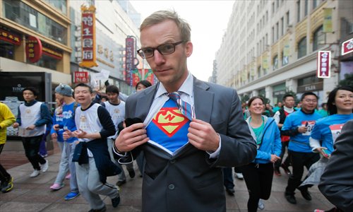 A superhero reveals his identity as he races along Nanjing Road East. Photo: Cai Xianmin/GT