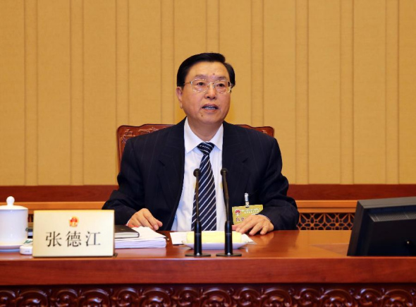 Zhang Dejiang, chairman of the Standing Committee of China's National People's Congress (NPC), presides over the first plenary meeting of the sixth session of the 12th NPC Standing Committee in Beijing, capital of China, Dec. 23, 2013. (Xinhua/Liu Weibing)