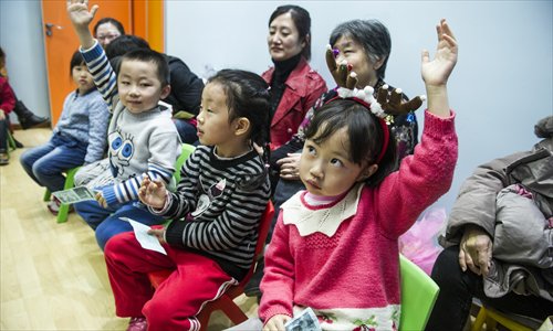 A young girl gets into the Christmas spirit by wearing reindeer antlers during a class on December 24 at an English training center in Maliandao, Xicheng district. Photo: Li Hao/GT