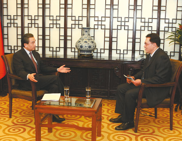 Foreign Minister Wang Yi talks with an Al Jazeera reporter during a recent interview. Provided to China Daily