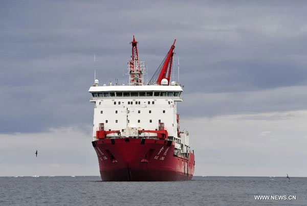 Chinese research vessel and icebreaker Xuelong docked in the waters nearby the Changcheng Station in Antarctica, Feb. 1, 2014. Over ten containers of waste and other scrapped vehicles from the Changcheng Station have been collected here recently in order to be shipped back for the sake of environmental protection. (Xinhua/Zhang Jiansong)