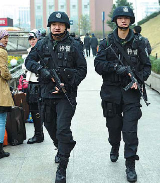 Police officers patrol the area around the railway station in Hangzhou, the capital of Zhejiang province. Long Wei / for China Daily