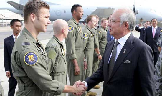 Malaysia's Prime Minister Najib Razak (R) meets with RAAF P3 Orion captain  Lieutenant Russell Adams (L) and his crew involved in the search for missing  Malaysia Airlines flight MH370at RAAF Pearce Air Base in Bullsbrook, 35 kms north of Perth on April 3, 2014.