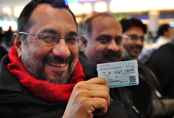 A foreigner shows his train ticket for a trip from Ningbo, Zhejiang province, to Shanghai during the Spring Festival travel rush this year. Hu Xuejun / For China Daily