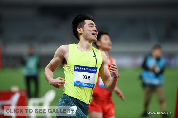 China's Xie Wenjun corsses the finish line during the men's 110m hurdles race at the IAAF Diamond League Athletics in Shanghai, east China, May 18, 2014. (Xinhua/Li Jundong)