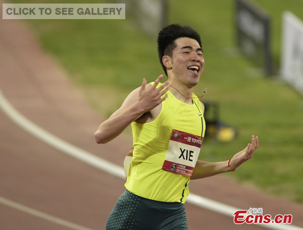 China's Xie Wenjun celebrates after winning the men's 110m hurdles in the 2014 IAAF World Challenge Beijing meet at the National Stadium in Beijing on Wednesday, May 21, 2014. (Photo: China News Service/Hou Yu)