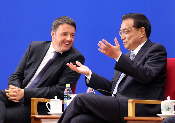 Premier Li Keqiang and his Italian counterpart Matteo Renzi attend a business seminar in Beijing on Wednesday. Wu Zhiyi / China Daily