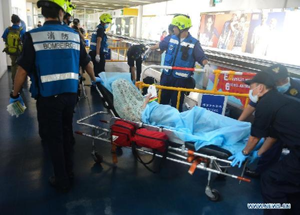 Rescuers transfer an injured passenger at a ferry terminal in Macao, south China, June 13, 2014. (Xinhua/Cheong Kam Ka)