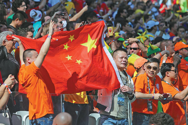 Chinese soccer fans enjoy the spectacle before a World Cup match between the Netherlands and Chile at the Arena de Sao Paulo in Brazil on June 23. Xu Zijian / Xinhua