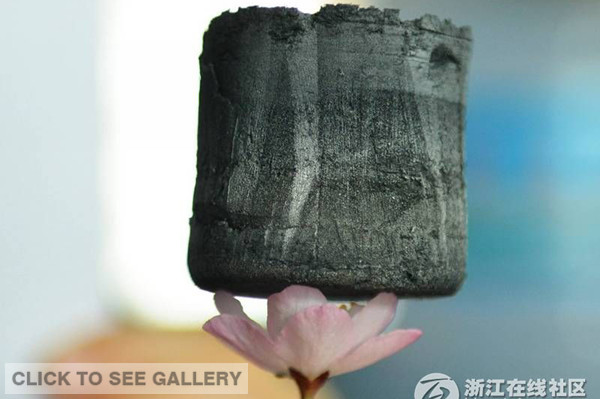 The undated photo shows a graphene aerogel, the world's lightest solid material, developed by scientists of Zhejiang University. It was sold for 10 million yuan ($1.61 million) at an auction of scientific achievements in Hangzhou city, capital of Zhejiang province on July 1, 2014. It is also one of the most oil-absorbent materials. [Photo: zjol.com.cn] 