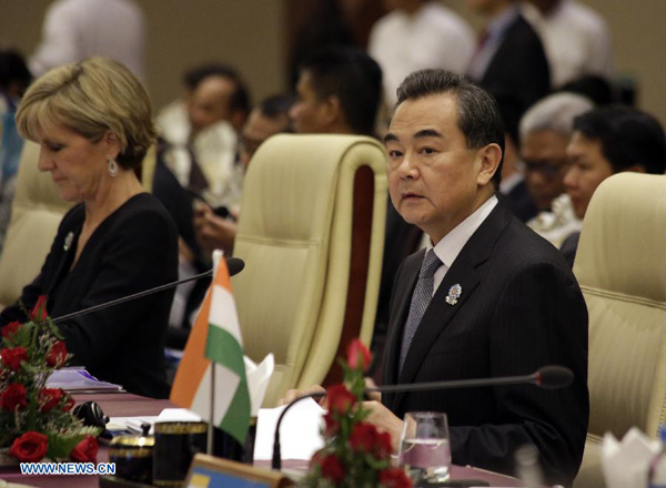 Chinese Foreign Minister Wang Yi (R) attends the 4th East Asia Summit (EAS) Foreign Ministers' Meeting at Myanmar International Convention Center in Nay Pyi Taw, Myanmar, Aug 10, 2014. (Xinhua/U Aung)