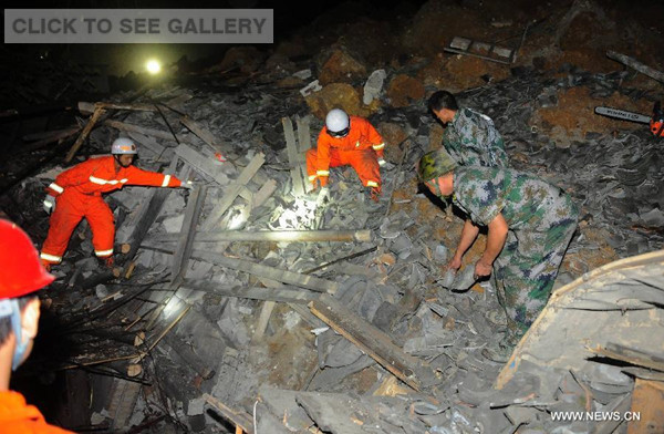 Rescuers work at the site of landslide in Yingping Village in Fuquan City, southwest China's Guizhou Province, on Aug. 28, 2014. One person was killed, and eleven remain missing after a landslide struck a village in southwest China's Guizhou Province on Wednesday night. (Xinhua/Liu Xu)