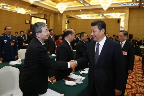 Chinese President Xi Jinping (front R), also general secretary of the Communist Party of China (CPC) Central Committee and chairman of the Central Military Commission, visits members of the 12th National Committee of the Chinese People's Political Consultative Conference (CPPCC) and joins their panel discussion in Beijing, capital of China, March 4, 2015. (Xinhua/Ju Peng)