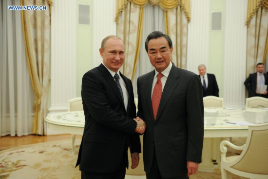 Russian President Vladimir Putin (L) meets with visiting Chinese Foreign Minister Wang Yi in Moscow, Russia, on April 7, 2015. China and Russia will work together to deepen their comprehensive strategic partnership in order to promote the development of both countries and contribute to a lasting world peace. (Xinhua/Dai Tianfang)