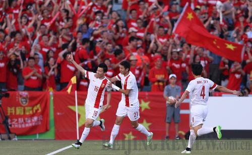 JOYFUL MOMENT: Chinese football player Sun Ke (left) waves to fans after scoring a goal during a game against the North Korean Football Team at the Asian Cup in Canberra, Australia, on January 18 (XINHUA)