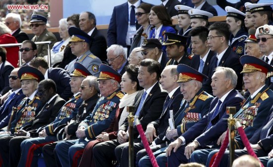 Chinese President Xi Jinping (5th R, front) and his wife Peng Liyuan attend a grand military parade to mark the 70th anniversary of the victory of the Great Patriotic War, with Russian President Vladimir Putin and other leaders, in Moscow, Russia, May 9, 2015. Xi, hosted by Putin, was among more than 20 leaders of countries, regions and international organizations to attend the commemorative event. (Xinhua/Ju Peng)