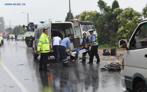 Traffic policemen help in rescuing the injured during an accident in Xiaogan, central China's Hubei Province, June 7, 2015.  (Xinhua/Li Wenyong)