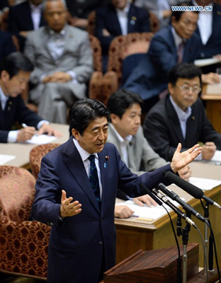 Japanese Prime Minister Shinzo Abe gestures as he speaks during a Diet debate among the parties' heads in Tokyo on June 17, 2015. (Photo: Xinhua/Ma Ping)