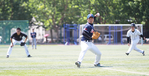 A player is about to pitch a ball during a match at the University of International Business and Economics in Beijing in June. (China Daily/Guan Xin)